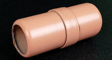 Beige cylindrical object on a black background