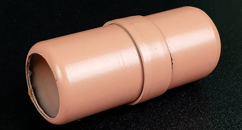 Beige cylindrical object on a black background
