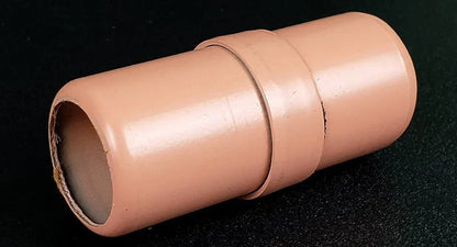 Beige cylindrical object on a black background