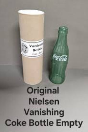 Vanishing Coca-Cola bottle prop and cardboard tube labeled 'Original Nielsen Vanishing Coke Bottle Empty' on a gray background.