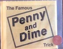 Book titled 'The Famous Penny and Dime Trick' with a pink button on a wooden surface.