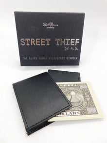 Black wallet and dollar bill with 'Street Thief' packaging on a white background