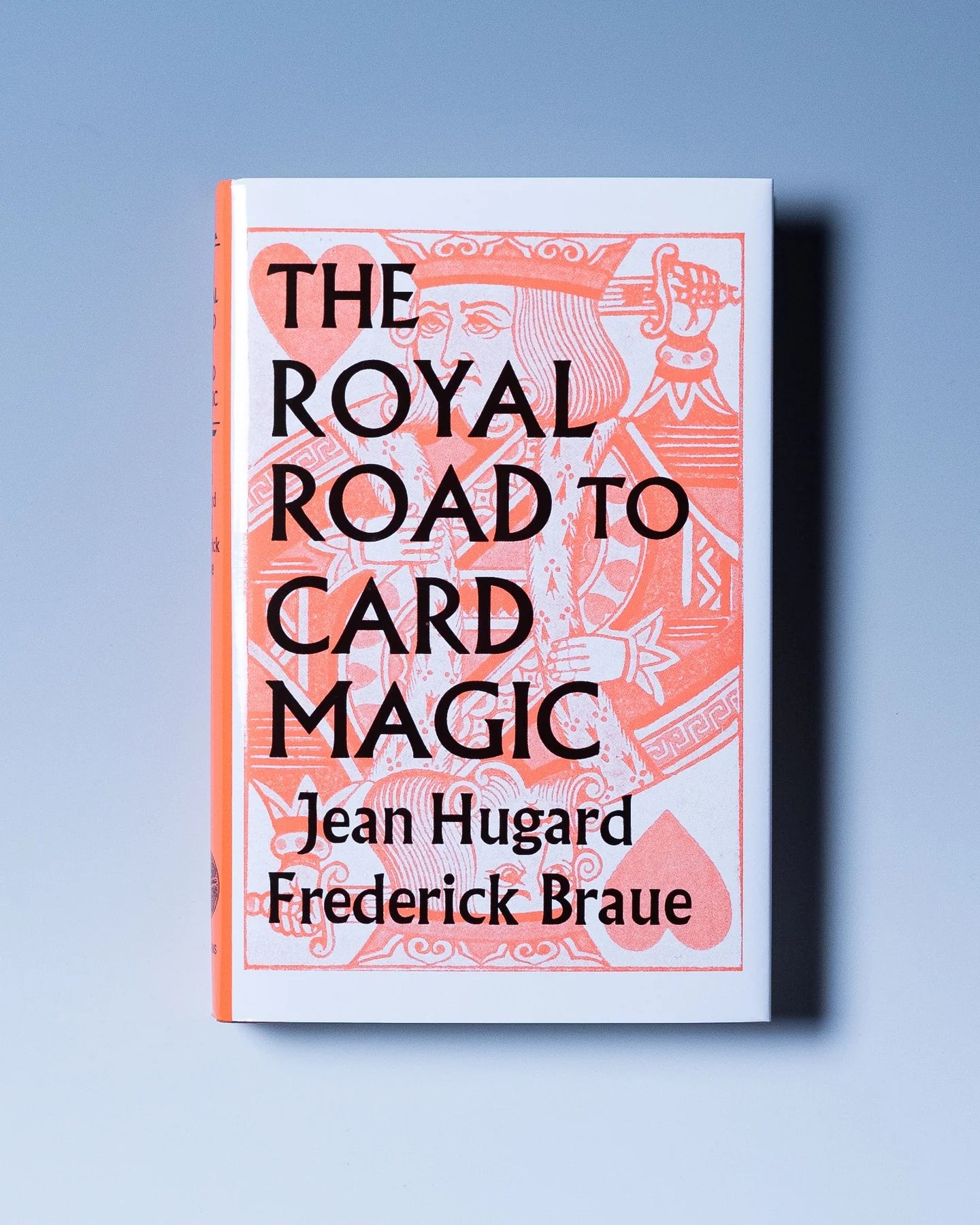 Book cover of 'The Royal Road to Card Magic' with decorative design on a light blue background