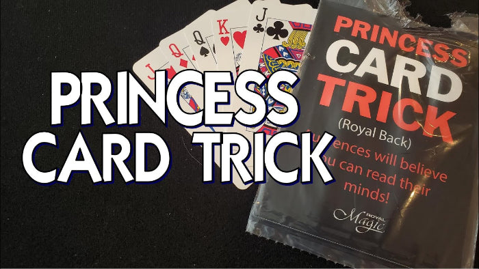 Playing cards and a package labeled 'Princess Card Trick' on a black background