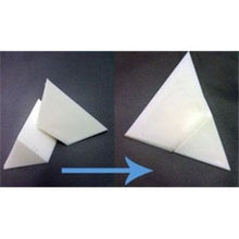 Step-by-step process of folding a white paper triangle on a dark background