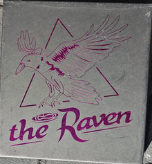 Book cover of 'The Raven' with a purple bird illustration on a gray background