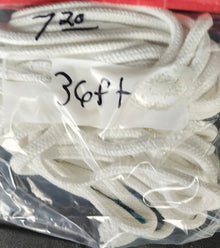 White soft magician rope in a clear plastic bag with measurements written on it.