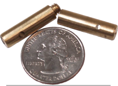 Two small brass cylindrical objects next to a quarter on a white background with text 'Quarter Not Included'.
