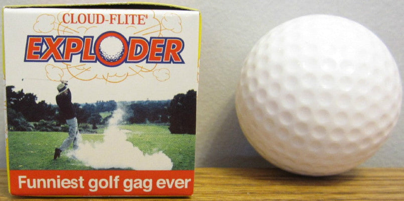 Golf ball next to a box labeled 'Cloud-Flite Exploder' on a wooden surface.