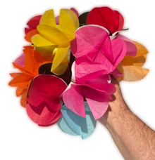 Hand holding a colorful bouquet of paper flowers on a white background
