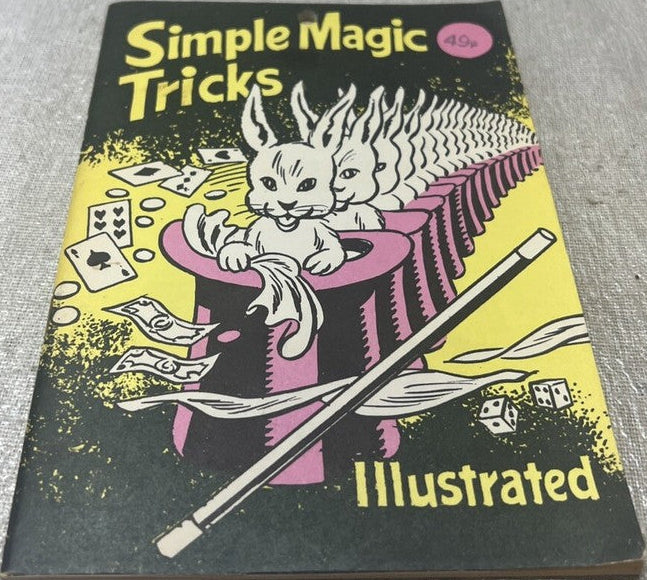 Book titled 'Simple Magic Tricks Illustrated' with a cat in a top hat and魔术棒 on a yellow background.