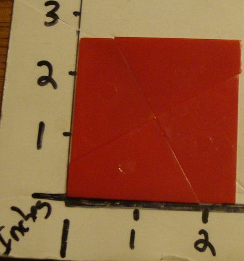 Magic square puzzle in packaging on a ruler for scale