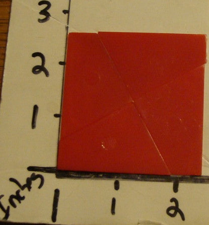 Magic square puzzle in packaging on a ruler for scale