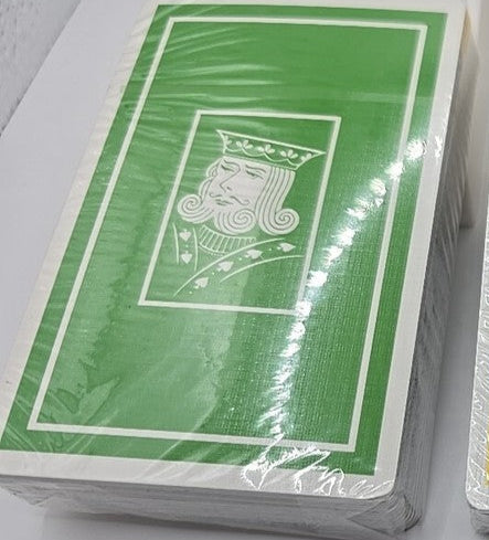 Four decks of playing cards in different colors on a white background