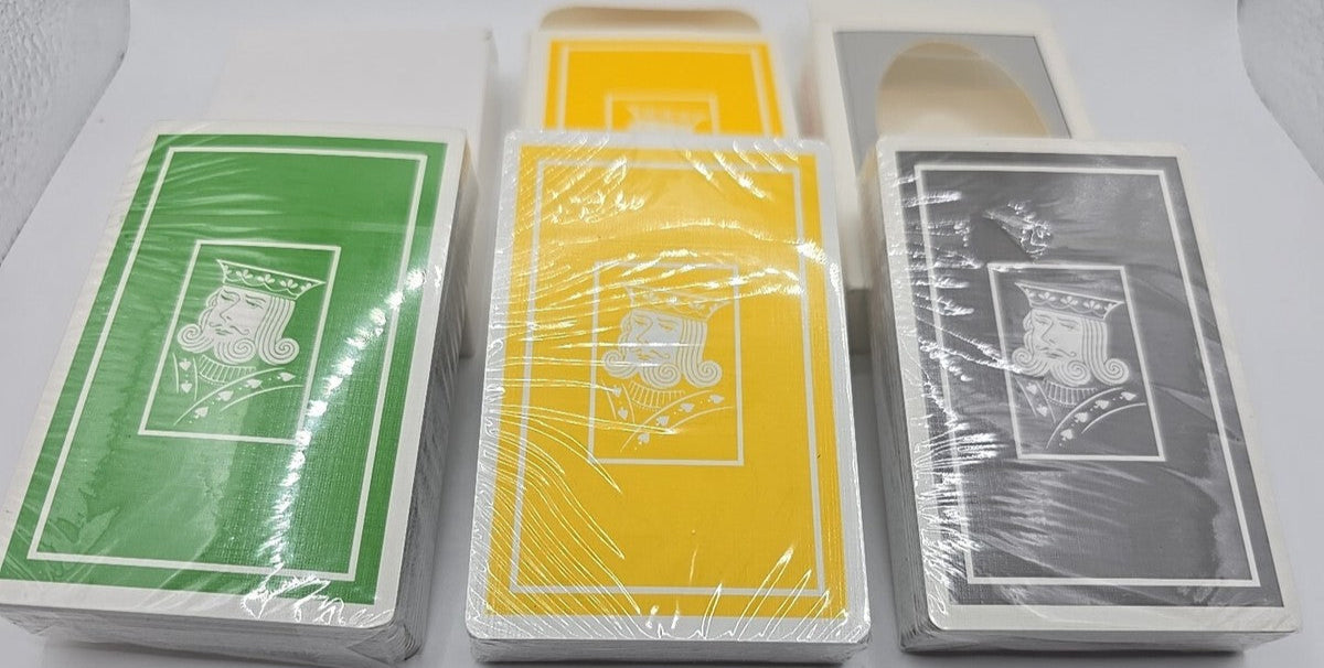 Four decks of playing cards in different colors on a white background