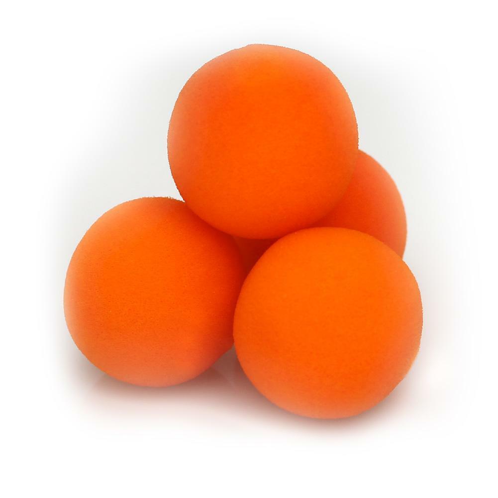 Three orange foam balls stacked on a white background