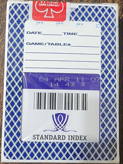 Playing card box with label on a wooden surface