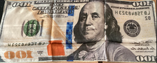 Falsified $100 bill with altered text