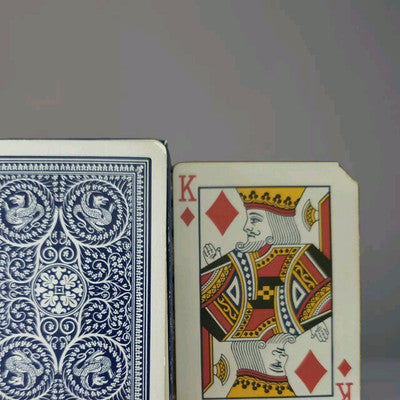 Playing card with King of Diamonds design on a gray background