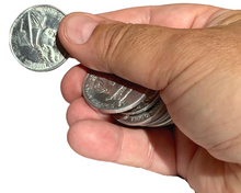 Hand holding a stack of coins against a white background