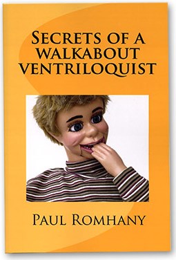 Book cover of 'Secrets of a Walkabout Ventriloquist' by Paul Romhany with a ventriloquist dummy on an orange background.