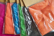 Colorful silk scarves in packaging with Pyramid Gold Magic branding.