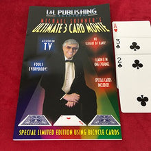 Magical trick book with a magician on the cover and playing cards beside it on a red background