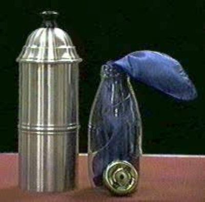 Metallic container with a blue glass bottle and gold cap on a dark background
