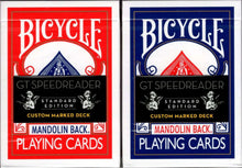 Two Bicycle playing card decks, one red and one blue, on a white background.