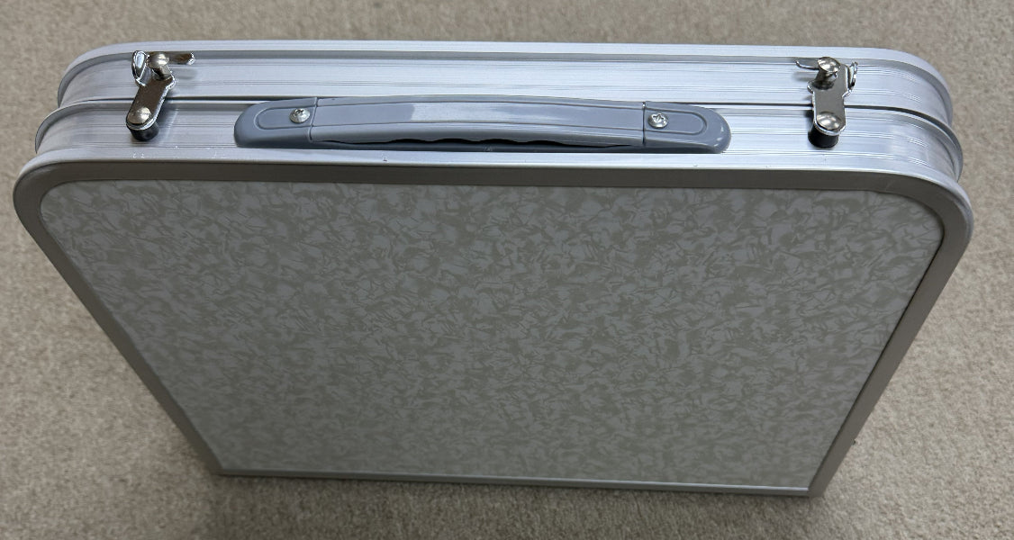 Silver suitcase on a gray background