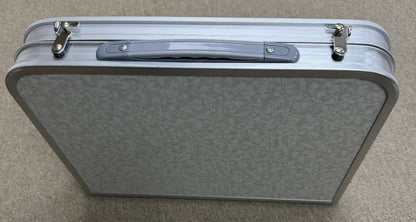 Silver suitcase on a gray background