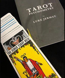 Tarot cards with a book titled 'Tarot Psychometry' by Luke Jermay on a black background