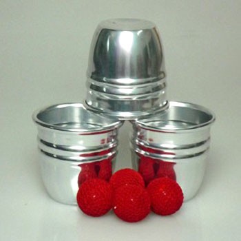 Metallic containers with red balls on a white background