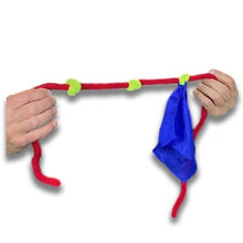 Red and green toy with a blue bag held by hands on a white background