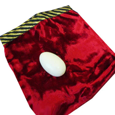 Red velvet pouch with a white egg inside on a white background